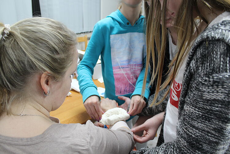 Üben von Verbänden in einem Erste-Hilfe-Kurs